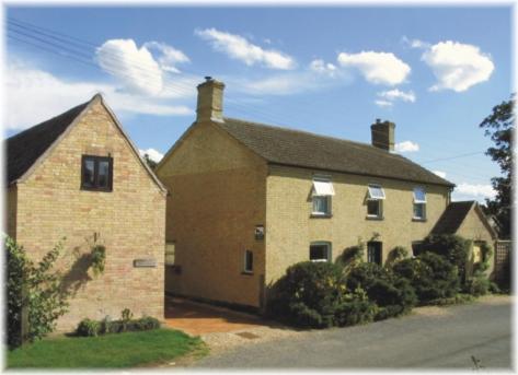 a large brick house sitting on the side of a street at Ye Olde Globe & Chequers in Huntingdon