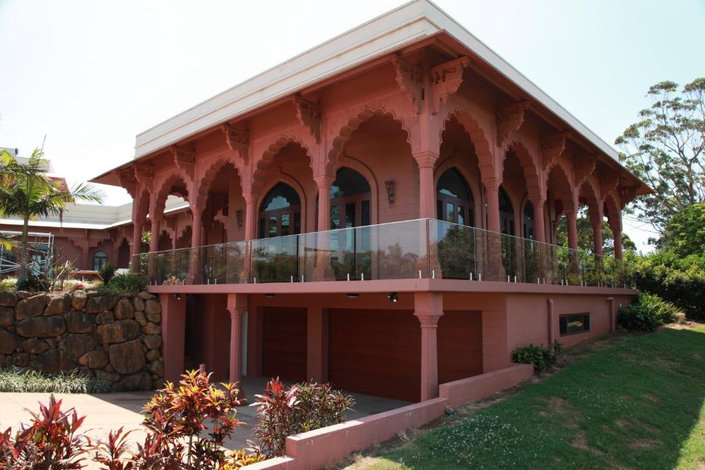 a building with a balcony on the side of it at Jodha Bai Retreat in Terranora