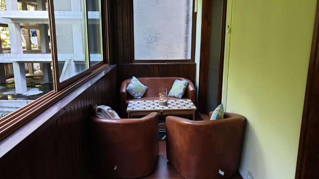 a table and two chairs in a room with a window at GREEN VIEW in Sinaia