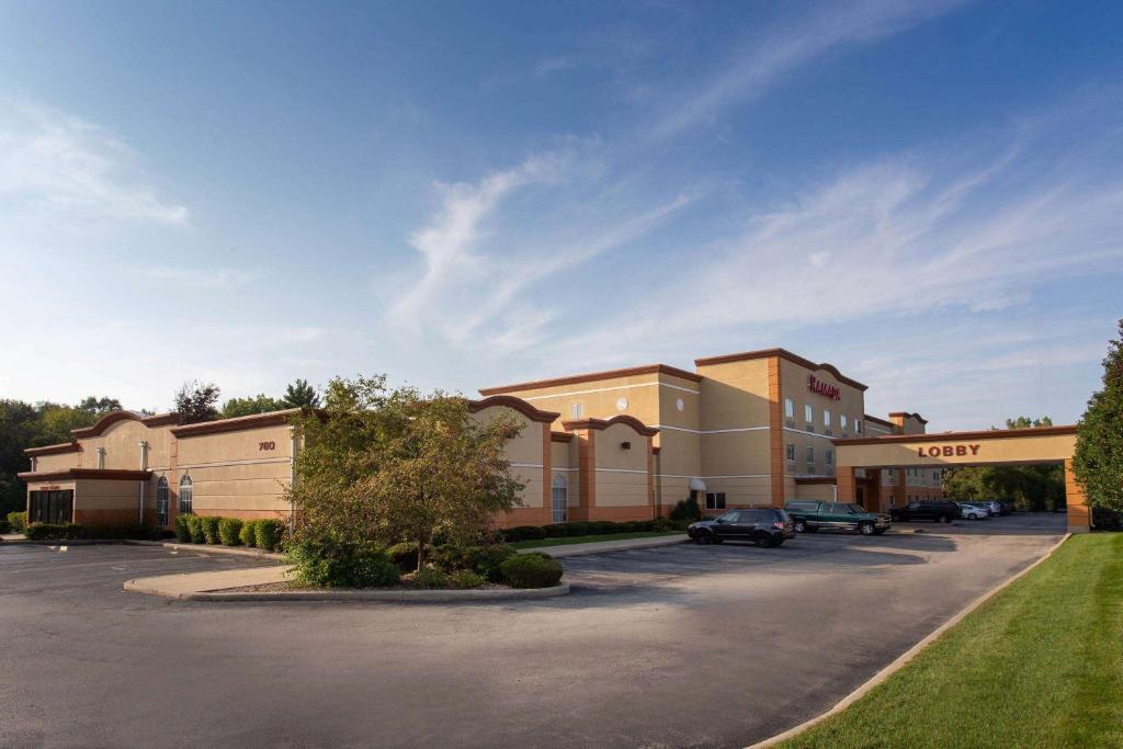 a parking lot in front of a shopping center at Ramada by Wyndham Glendale Heights/Lombard in Glendale Heights