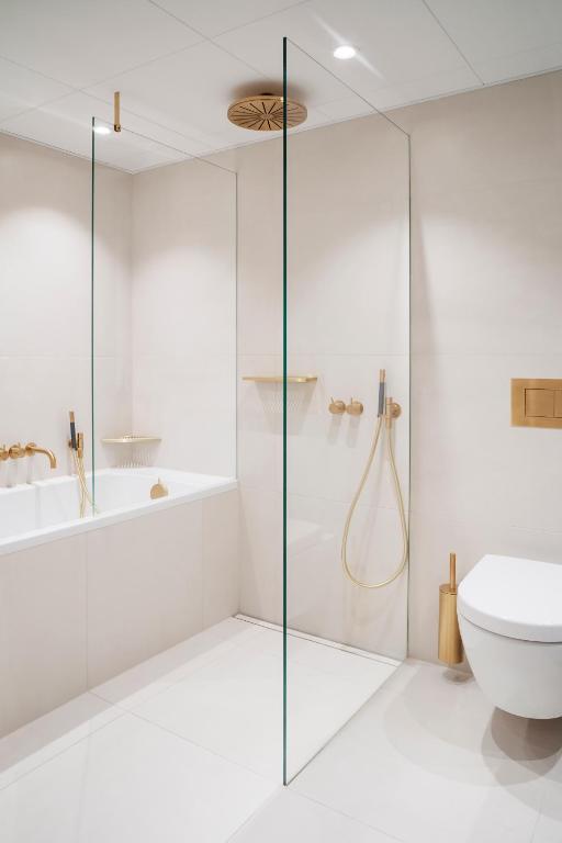 a bathroom with a glass shower and a toilet at Copenhagen Admiral Hotel in Copenhagen