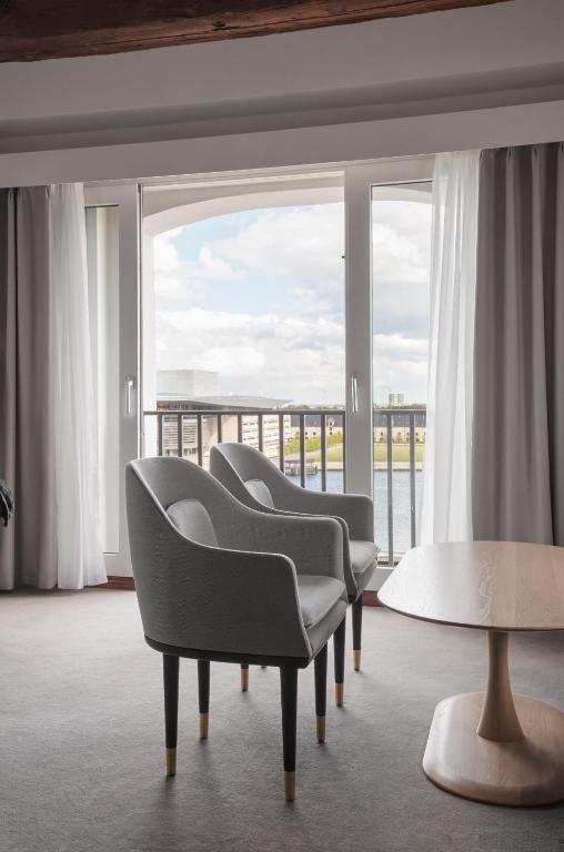 a room with chairs and a table and a large window at Copenhagen Admiral Hotel in Copenhagen