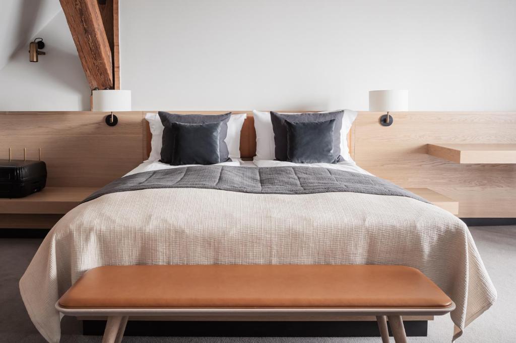 a bedroom with a large bed with a wooden headboard at Copenhagen Admiral Hotel in Copenhagen