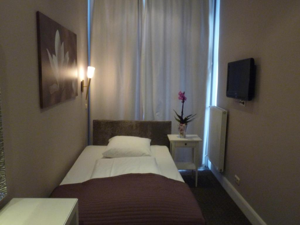 Postel nebo postele na pokoji v ubytování Hotel Commodore