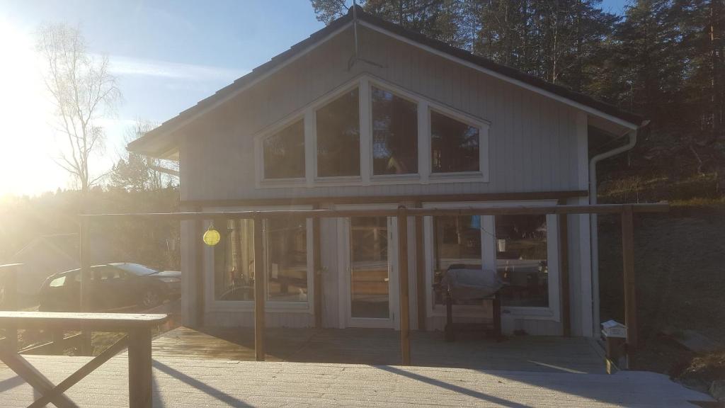 a house with sliding glass doors and a table at Värmdö Ängsv. in Djurhamn