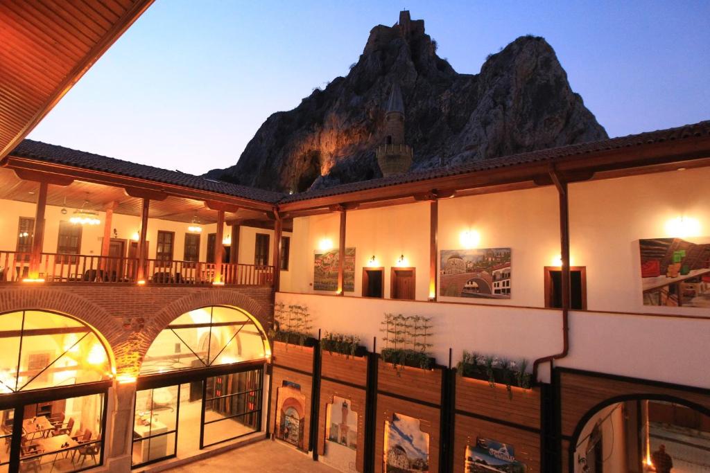 a building with a mountain in the background at Yazmacılar Hanı Otel Restaurant in Tokat