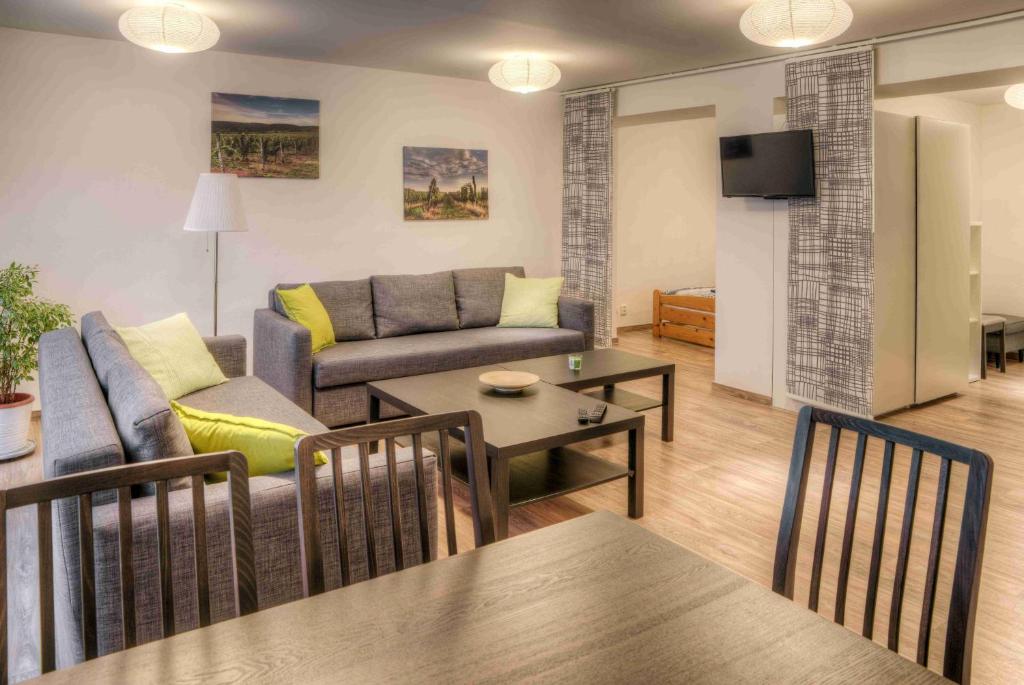 a living room with a couch and a table at Apartmány pod Divadlem in Znojmo