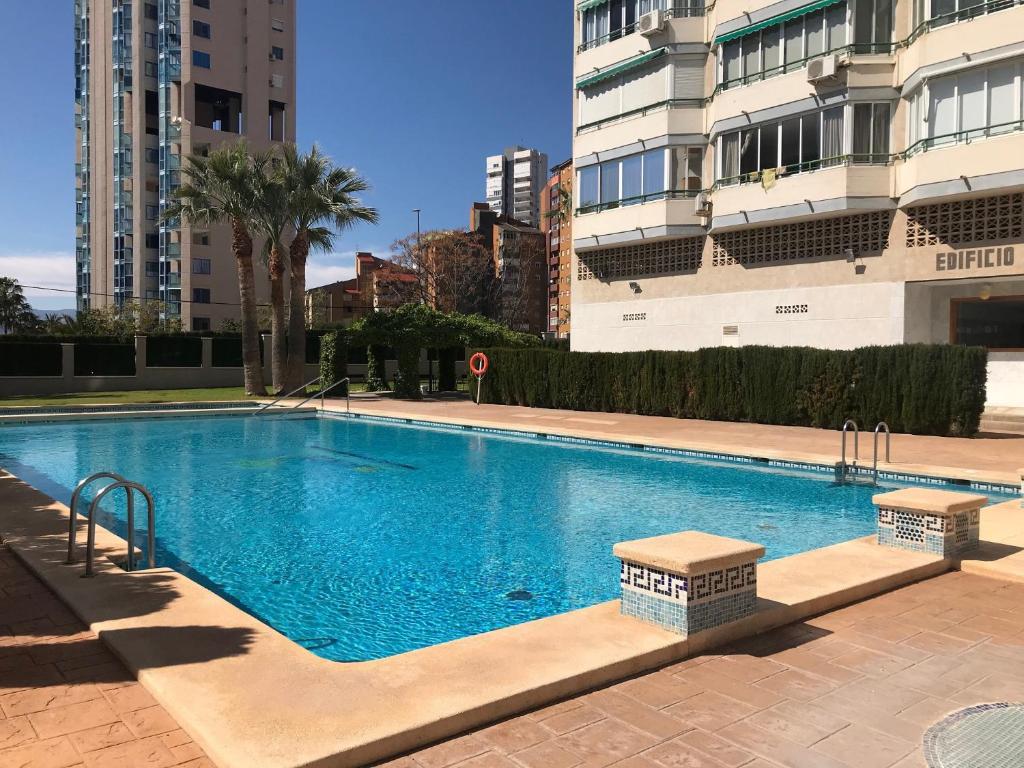 a large swimming pool in a city with tall buildings at Apartment In Poniente Beach in Benidorm