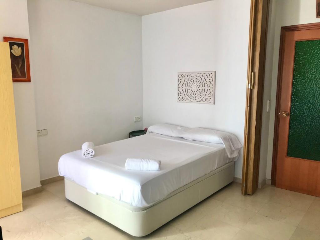 Posteľ alebo postele v izbe v ubytovaní San Roc Apartment