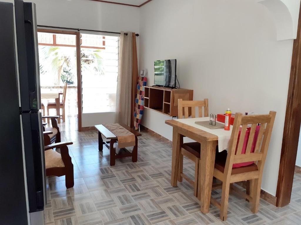 a kitchen and dining room with a table and chairs at One bedroom appartement with sea view enclosed garden and wifi at Baie Sainte Anne 5 km away from the beach in Baie Sainte Anne
