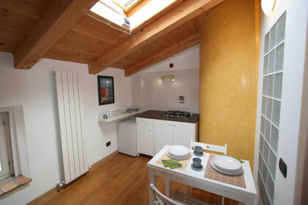 a small kitchen with a table in a room at Piazza Grande City Residence in Trieste