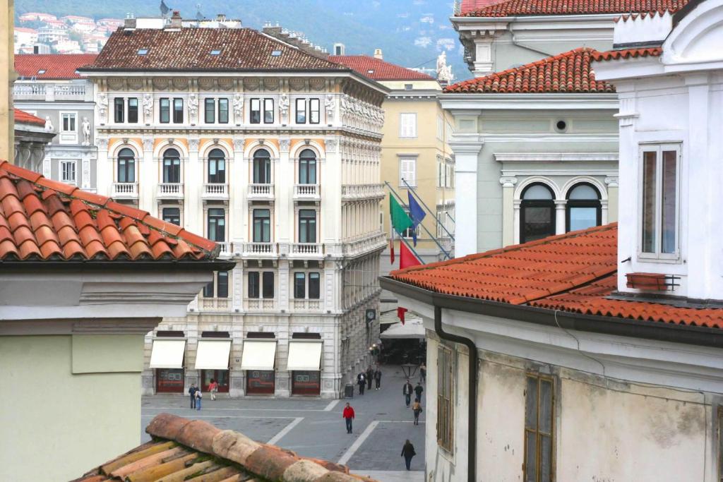 a view of a city street with buildings at Piazza Grande City Residence in Trieste