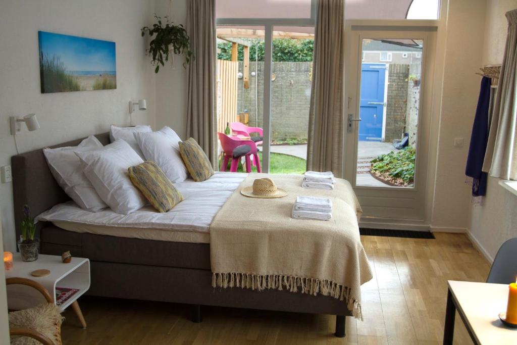 a bedroom with a bed with a table on it at Studio Zonnehoek Schoorl in Schoorl