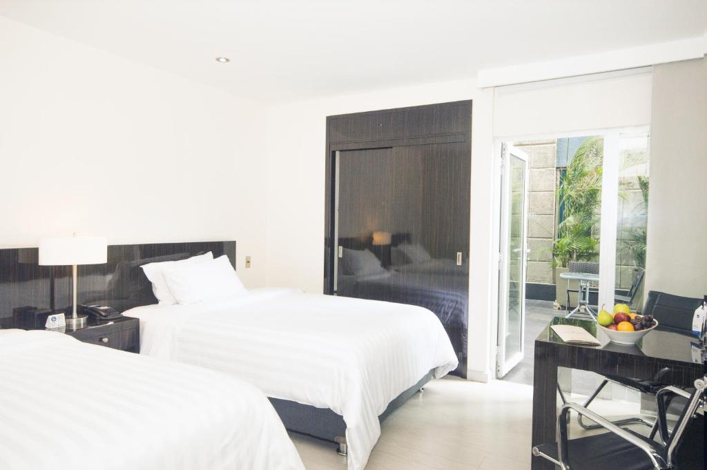 Postel nebo postele na pokoji v ubytování GHL Hotel Portón Medellín
