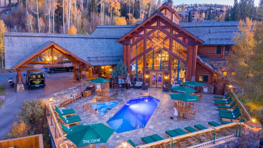 an aerial view of a log cabin with a pool and tables at Mountain Lodge Telluride in Telluride