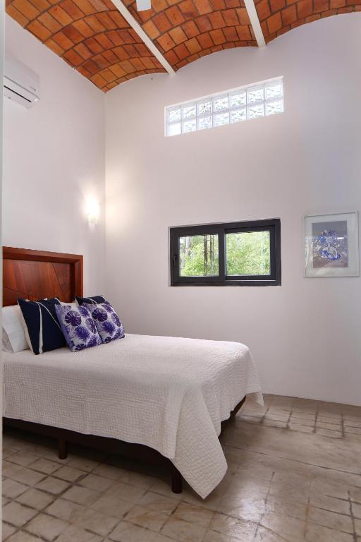 a bedroom with a bed in a white room at Villa Dorado B in Sayulita