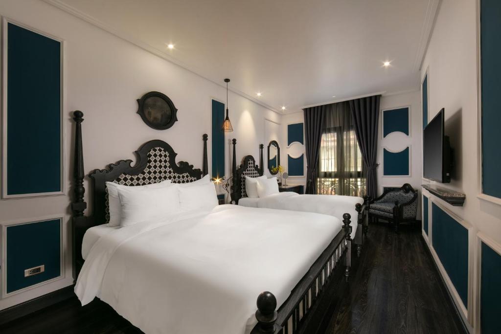 Postel nebo postele na pokoji v ubytování Hanoi Esplendor Hotel and Spa