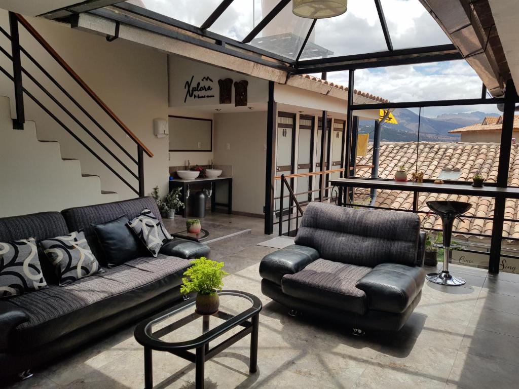 a living room with a couch and a table at Xplora Hostel Cusco in Cusco