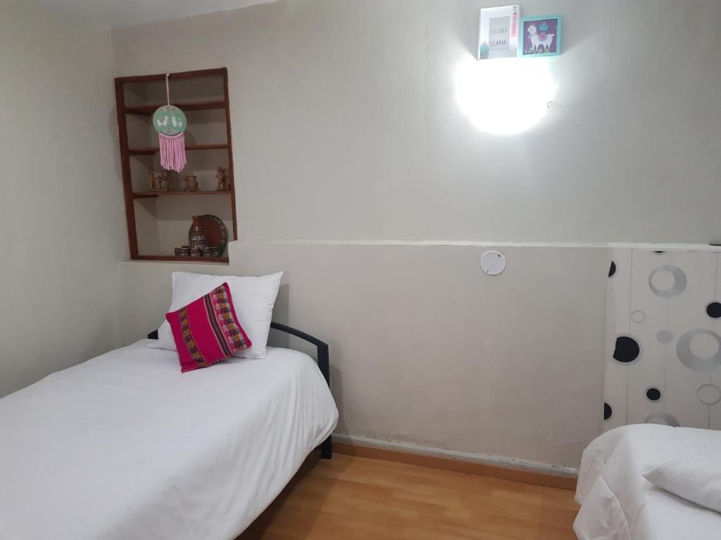 Ένα ή περισσότερα κρεβάτια σε δωμάτιο στο Xplora Hostel Cusco