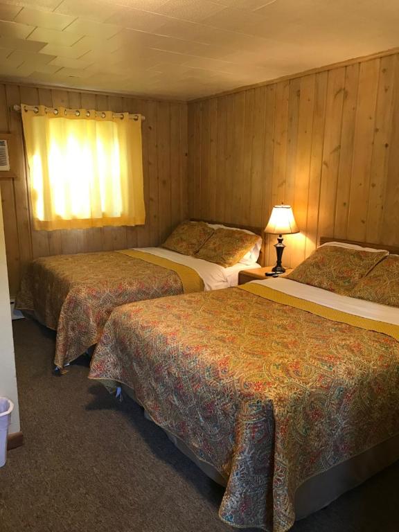 a hotel room with three beds in a room at Royal Motel in Ironwood