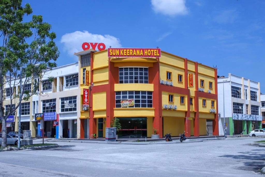 a yellow and orange building on a city street at OYO 89387 Sun Keerana Hotel in Klang