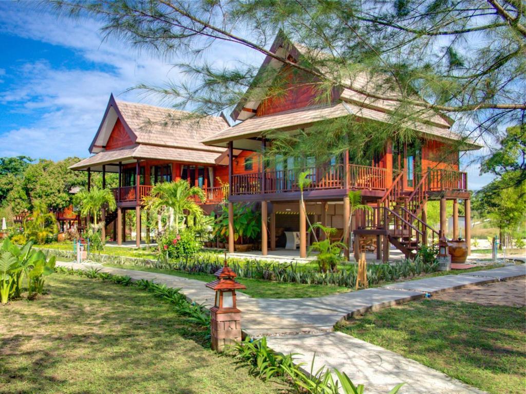 a house with a fire hydrant in front of it at ThaiLife Wellness & Meditation Resort- SHA Plus in Khao Lak