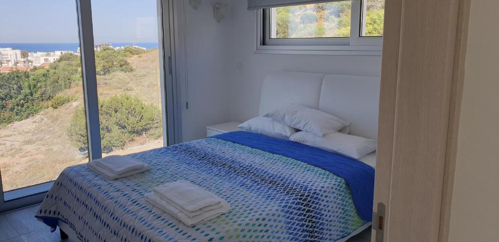 a bedroom with a bed with two towels on it at Villa Chrystalleni in Protaras