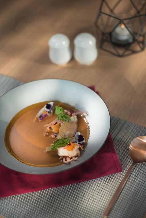 a bowl of soup sitting on a red napkin at HARRIS Resort Barelang Batam in Sagulung