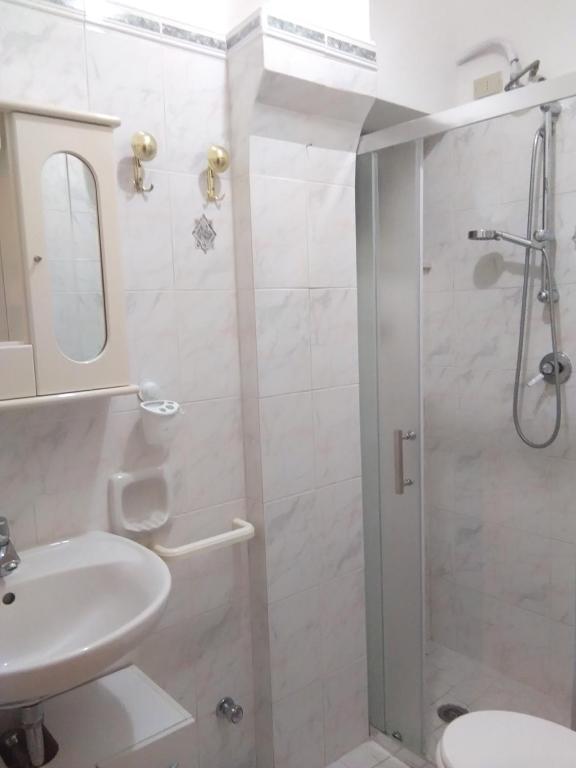 a bathroom with a shower and a sink and a toilet at GIARDINO SUL MARE in Amalfi