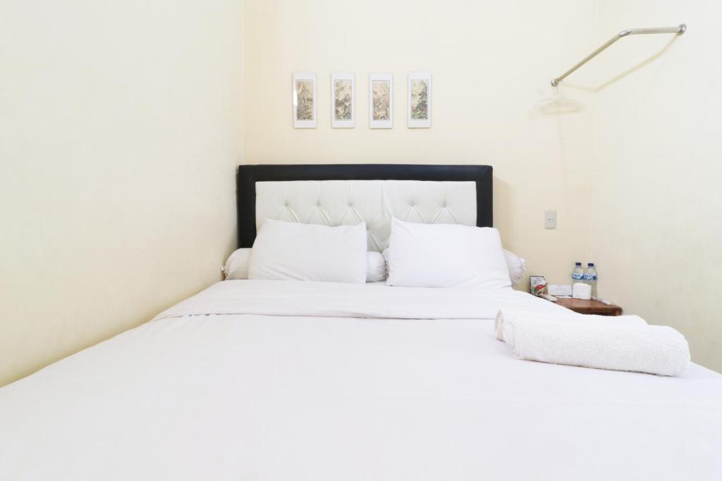 Postel nebo postele na pokoji v ubytování Krisna Hostel