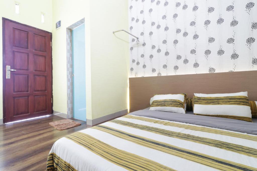 Postel nebo postele na pokoji v ubytování Krisna Hostel