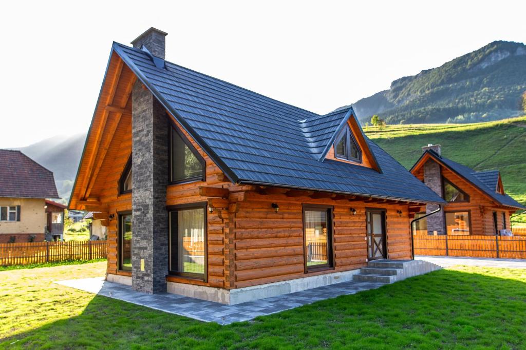 a log cabin with a black roof at Chata Zazrivka in Biela