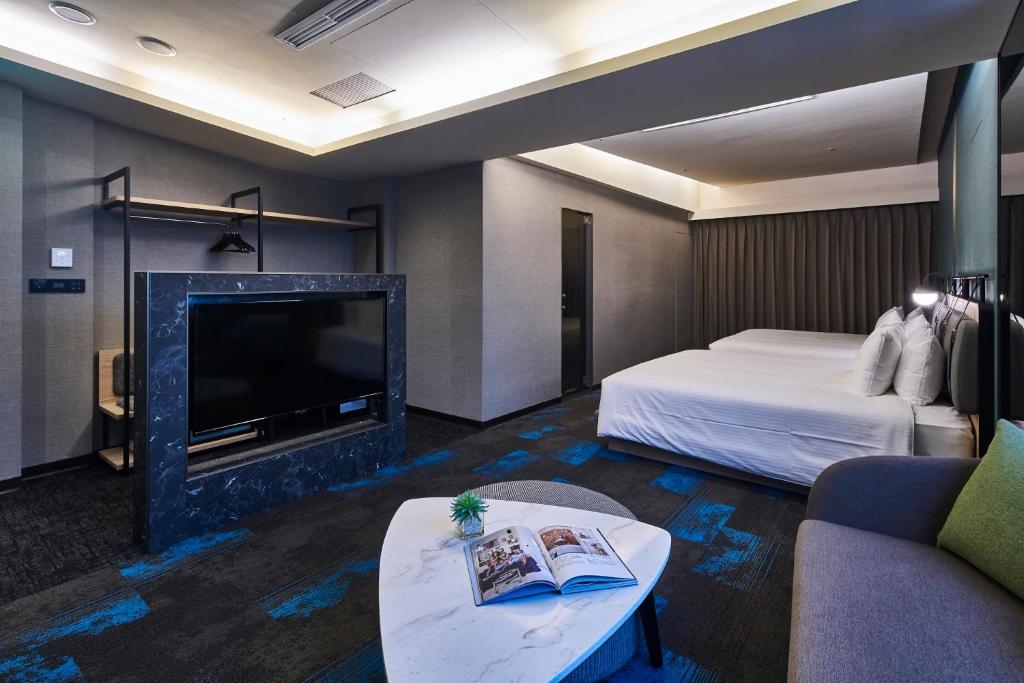 Postel nebo postele na pokoji v ubytování Kung Shang Design Hotel