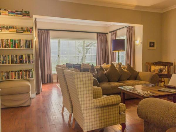 a living room with a couch and a table and chairs at 59 on Central in Johannesburg