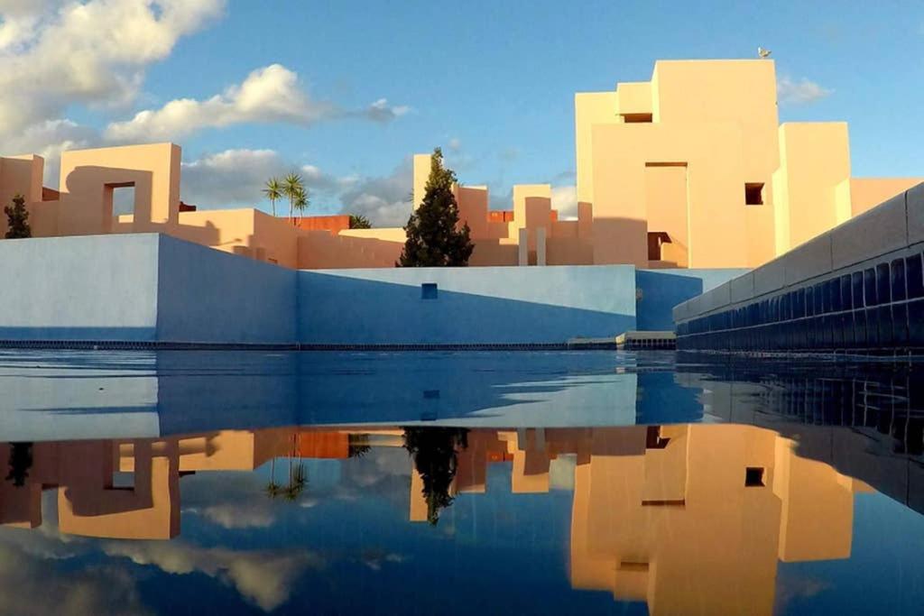 a rendering of a city with buildings and a body of water at La Muralla Roja in Calpe