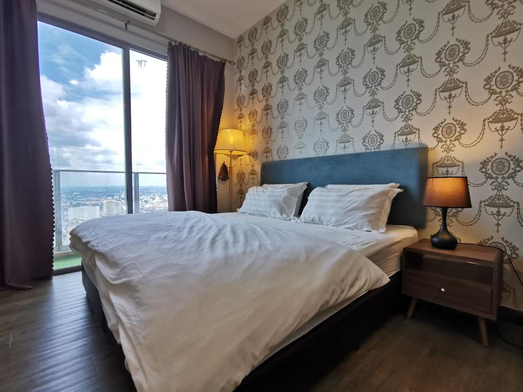 a bedroom with a large bed with a large window at Mykey Silverscape B-39-07 Melaka City in Melaka