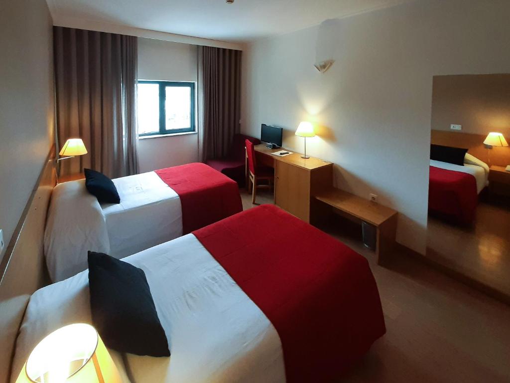 Postel nebo postele na pokoji v ubytování Hotel Durao