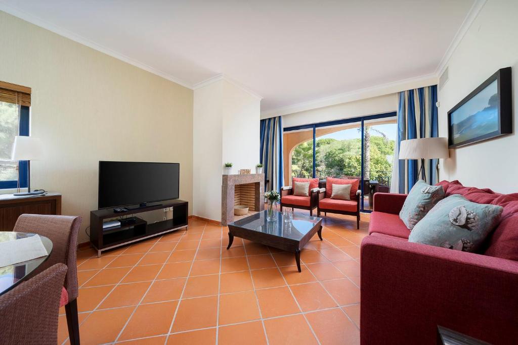 a living room with a couch and a tv at AL - Apartamento Vila Sol F5 Top Floor in Quarteira