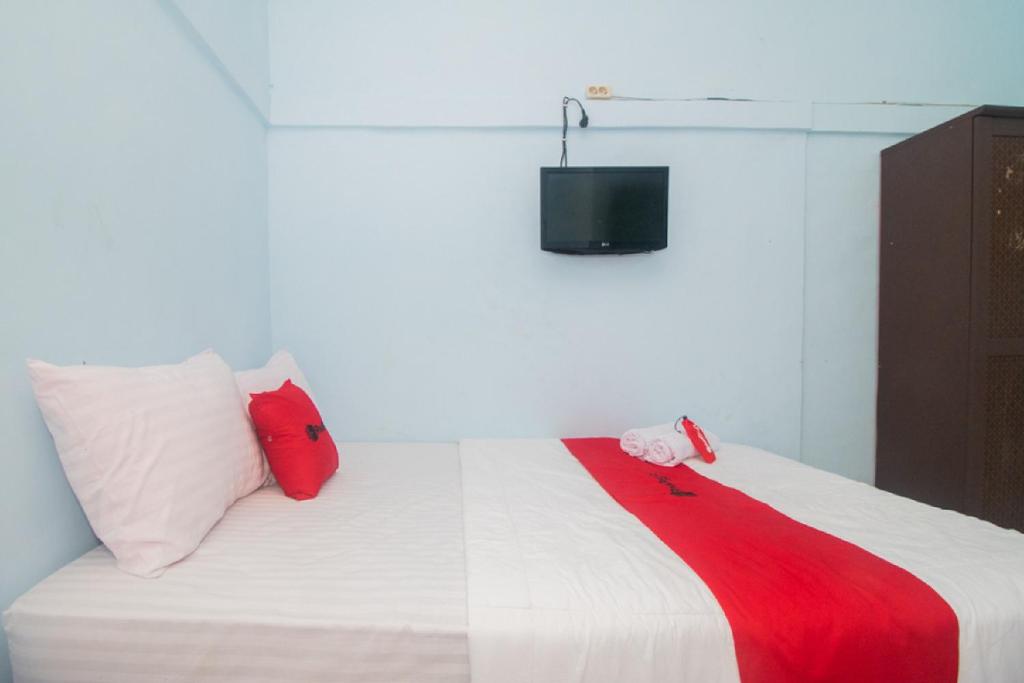 Postel nebo postele na pokoji v ubytování RedDoorz near Pantai Boom