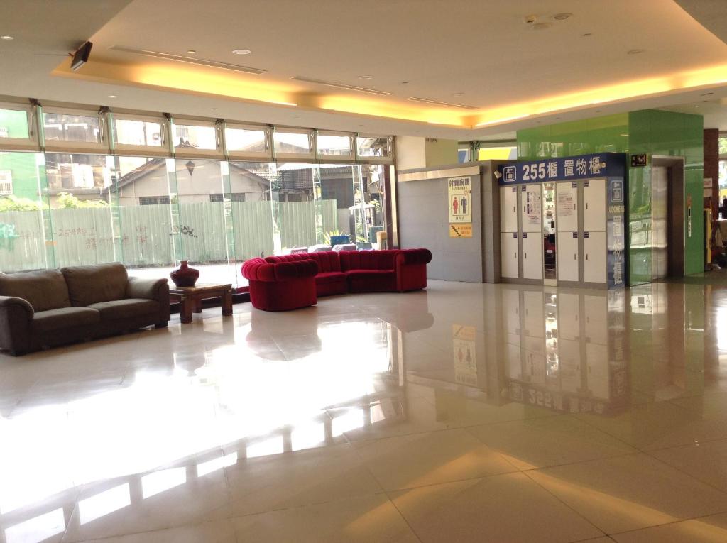a lobby with two couches and a gas station at Tie Dao Hotel in Tainan