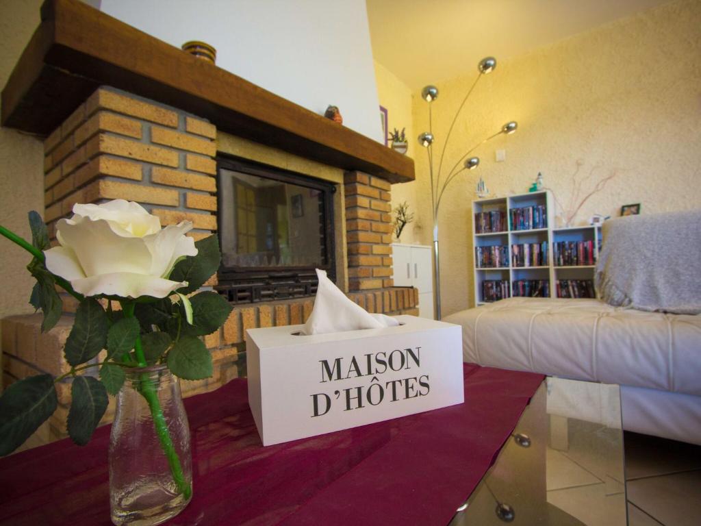 アルジュリエにあるHoliday Home in Argeliers with Swimming Poolの花瓶と看板のあるリビングルーム