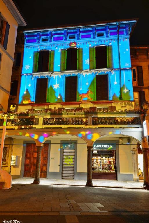 a large building with a blue lit up at La Casa sul Lago Lecco in Lecco