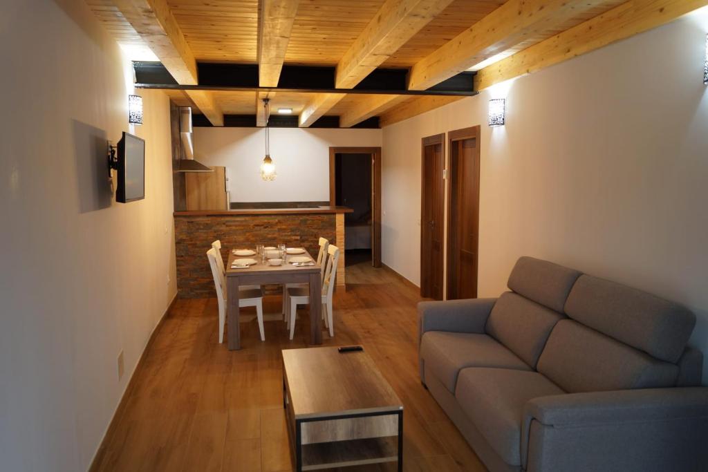 a living room with a couch and a table at Puente viejo de Buitrago casa Fresno in Buitrago del Lozoya