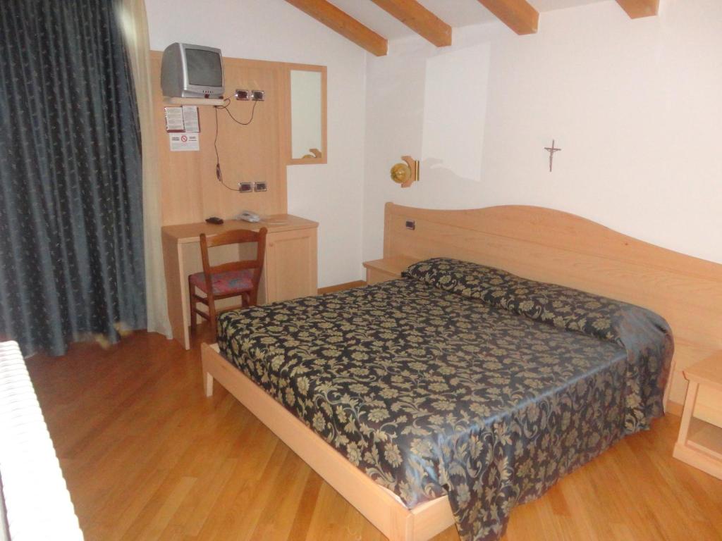 Postel nebo postele na pokoji v ubytování Hotel Al Caminetto