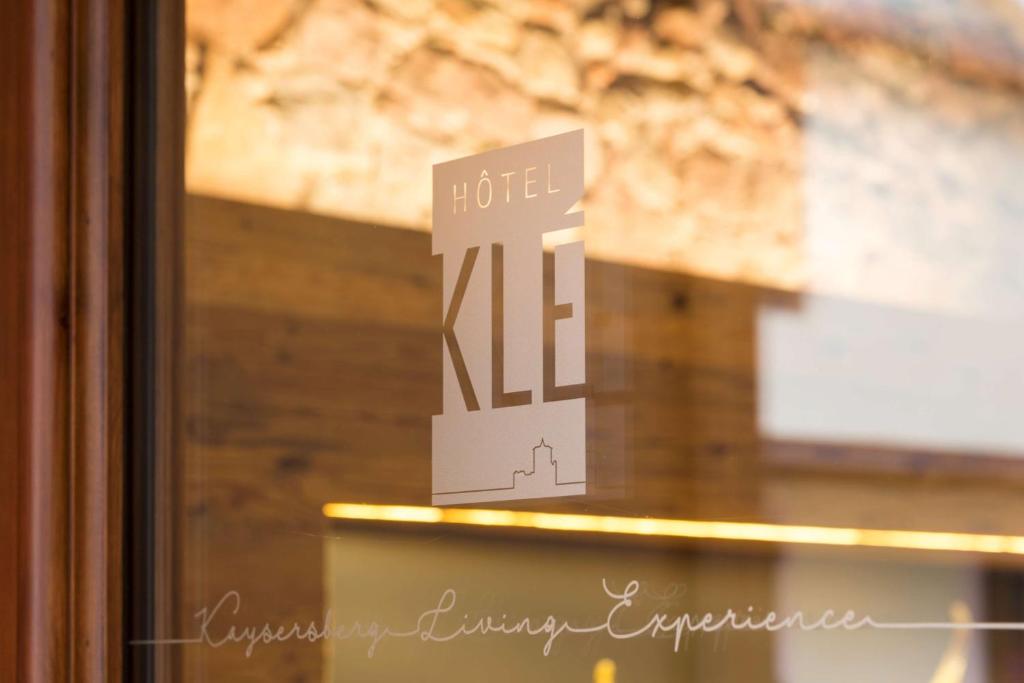 a white sign with a black and white background at Hotel KLE, BW Signature Collection in Kaysersberg