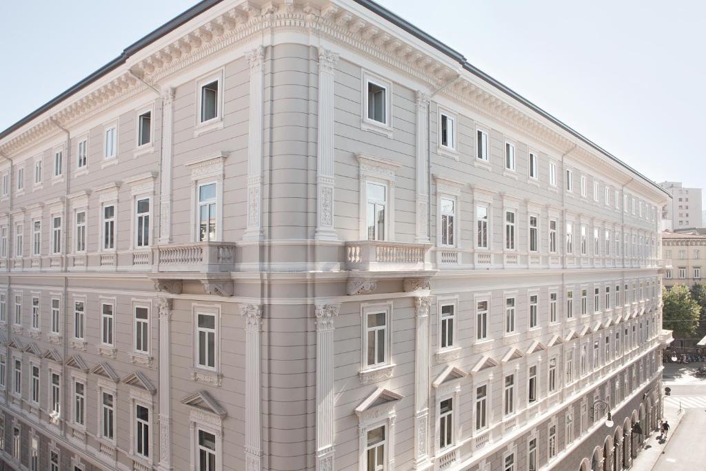 a white building with balconies on the side of it at Palazzo Talenti 1907 in Trieste