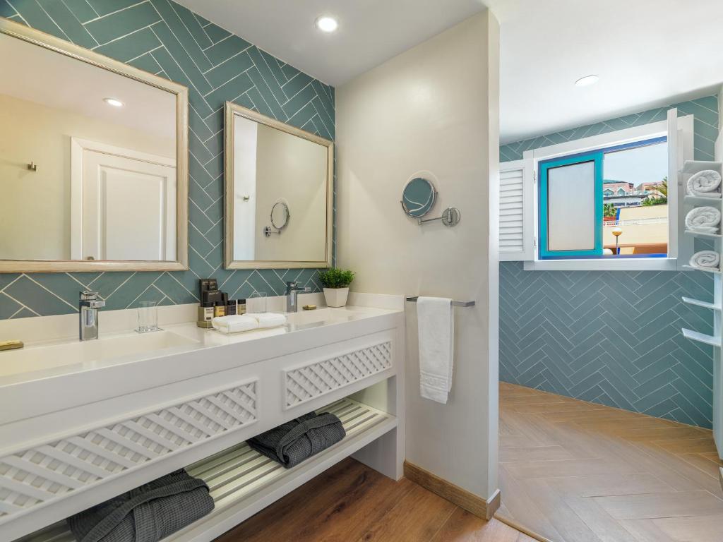 a bathroom with a sink and a mirror at H10 Playa Esmeralda - Adults Only in Costa Calma