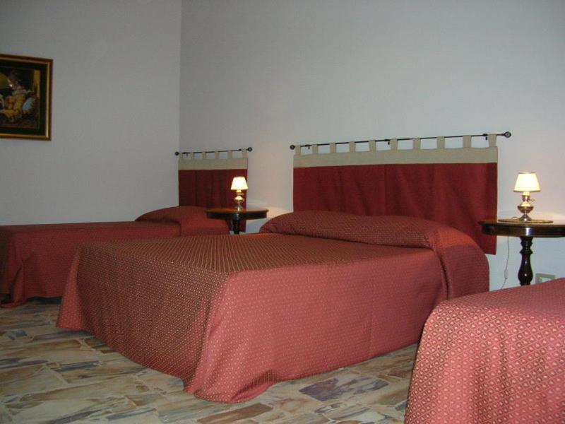 Łóżko lub łóżka w pokoju w obiekcie La Durlindana B&B