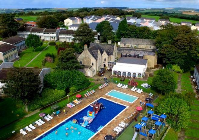 an aerial view of a large house with a swimming pool at Atlantic Reach Cottages, Newquay 6 miles, 2 Bedrooms in Newquay