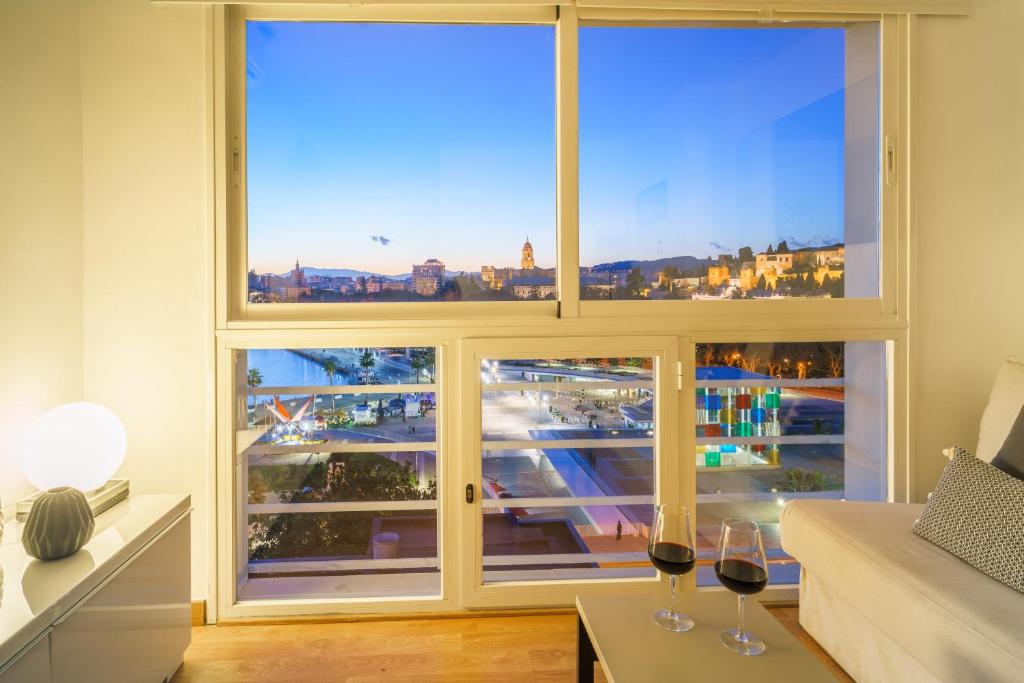 A bed or beds in a room at LU&CIA Málaga Skyline